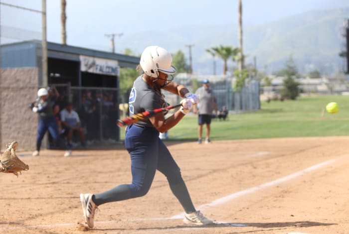 Jaeya Butler smashes one of her 12 home runs on the season. Photo: John Murphy